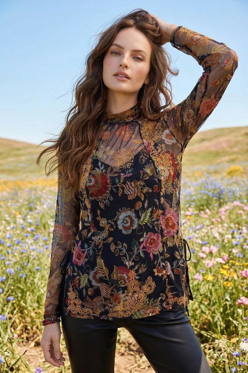 Woman wearing a long-sleeve floral mesh top with embroideries from Johnny Was
