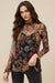 Woman wearing a long-sleeve floral mesh top with embroideries from Johnny Was