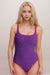 Woman wearing a purple eyelet tank one piece swimsuit from Johnny Was