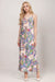 Woman wearing a colorful paisley patterned maxi slip dress from Johnny Was