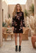 Woman wearing an animal-patterned velvet dress with floral embroideries and long kimono sleeves from Johnny Was