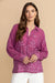 Woman wearing a purple embroidered button-down shirt with long sleeves from Johnny Was