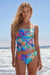Woman wearing a colorful floral-patterned tankini with ruching at the front from Johnny Was