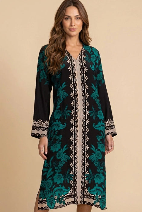 Woman wearing a black and teal floral silk midi dress with v-neck and long sleeves from Johnny Was