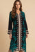 Woman wearing a black and teal floral silk midi dress with v-neck and long sleeves from Johnny Was