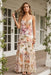 Woman wearing a floral maxi dress with tiered ruffle skirt and spaghetti straps from Johnny Was