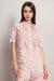 Woman wearing a pink crocheted shirt with scallop lace trim and button-down front from Johnny Was