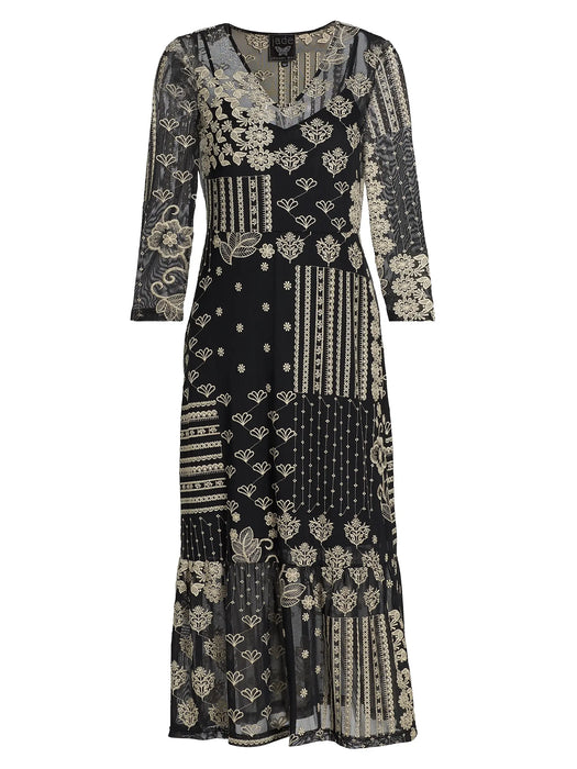 A black midi dress with three-quarter sleeves, featuring an intricate patchwork design of beige and off-white floral, geometric, and striped patterns, shown against a plain white background.