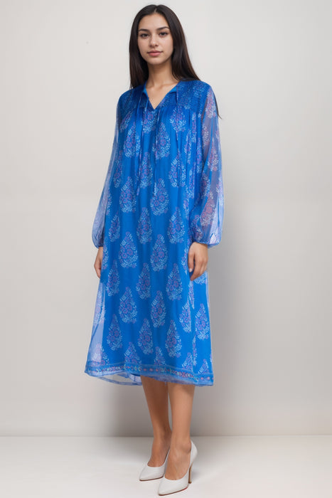 Woman wearing a blue lightweight silk midi dress with floral print