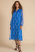 Woman wearing blue semi-sheer midi dress with floral print and long sleeves from Johnny Was