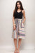 Woman wearing a geometric patterned A-line midi skirt with side pockets from Johnny Was