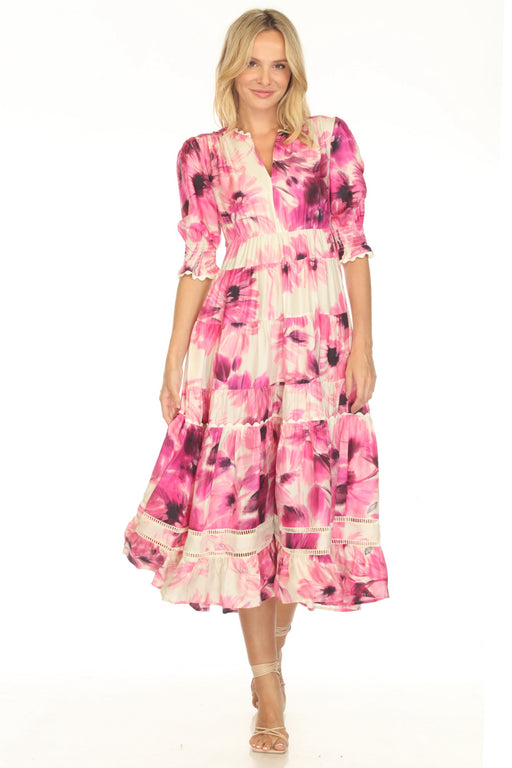 Woman wearing a pink floral midi dress with tiered skirt and puff sleeves from Johnny Was