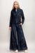 Woman wearing a dark denim wide leg pant with tone-on-tone embroidery and eyelet details from Johnny Was