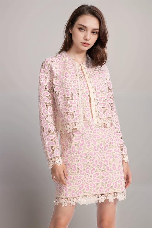 Woman wearing a pink crocheted cropped jacket with scallop lace trim and button front from Johnny Was