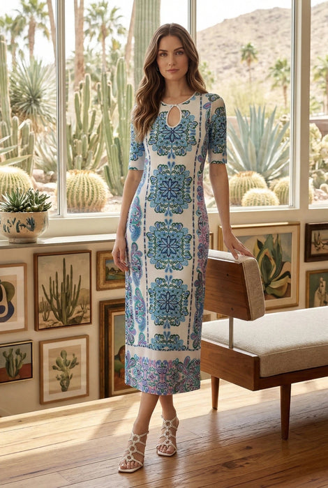 Woman wearing a white mesh midi dress with vibrant paisley embroidery and keyhole neck cutout from Johnny Was