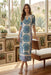 Woman wearing a white mesh midi dress with vibrant paisley embroidery and keyhole neck cutout from Johnny Was
