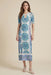 Woman wearing a white mesh midi dress with vibrant paisley embroidery and keyhole neck cutout from Johnny Was