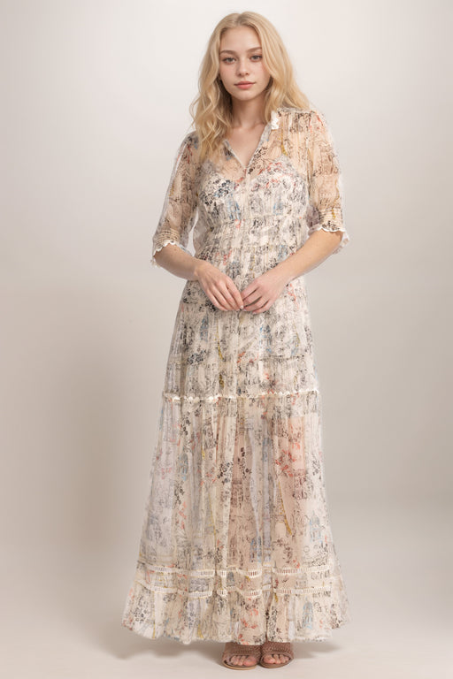 Woman wearing a lightweight silk maxi dress with floral and Paris architecture-inspired print from Johnny Was