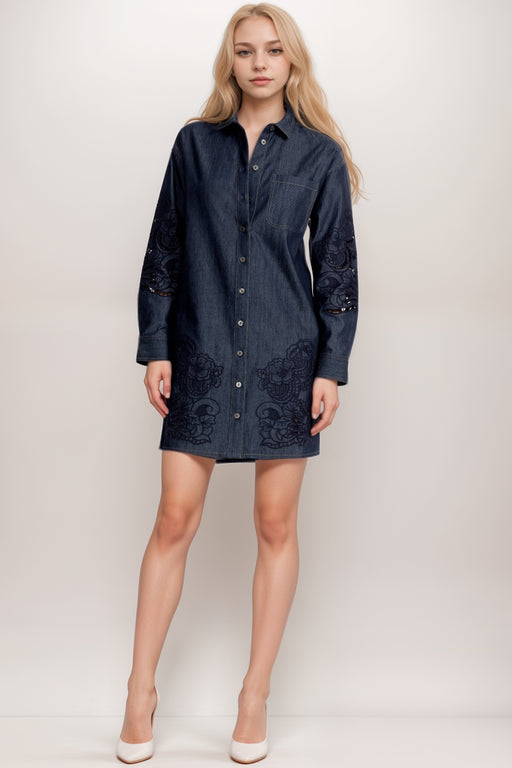 Woman wearing a dark denim shirt mini dress with tone on tone embroidery and eyelets