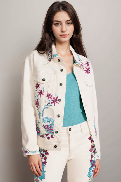 Woman wearing a cream-colored denim jacket with floral print