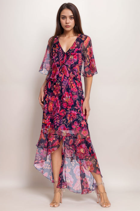 Woman wearing a lightweight silk maxi dress with floral print and ruffles from Johnny Was