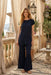 Woman wearing a dark blue pleated tunic top with short raglan sleeves from Johnny Was