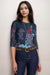 Woman wearing a navy mesh top with floral pattern and 3/4 sleeves from Johnny Was