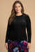 Woman wearing black paisley patterned mesh top with long sleeves from Johnny Was