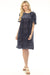 Woman wearing a navy mini shift dress with burnout velvet patterns from Johnny Was