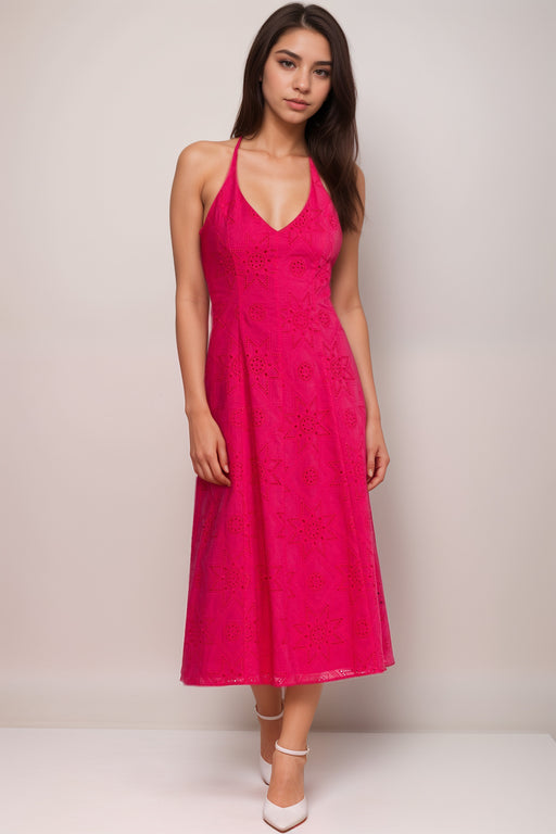 Woman wearing a bright pink halter midi dress with eyelets and embroidery from Johnny Was