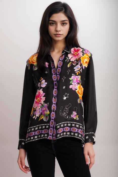 Woman wearing a silk blend long sleeve shirt with colorful floral print and button down closure