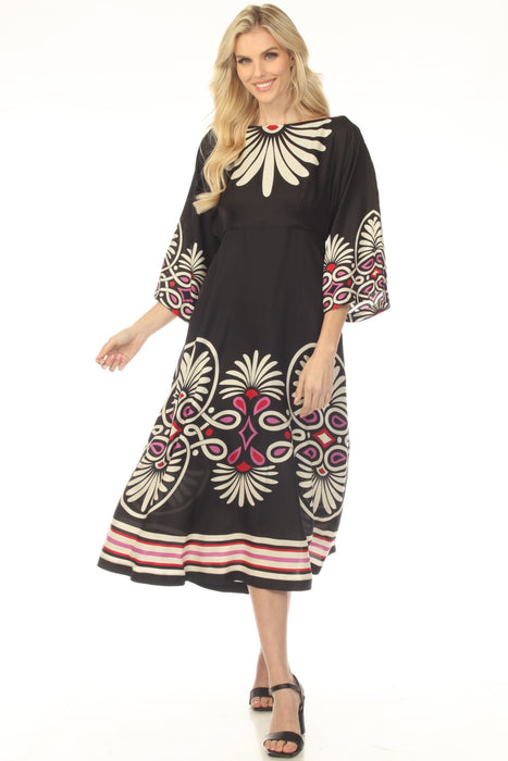 Woman wearing a black dress with colorful patterns and striped hem from Johnny Was