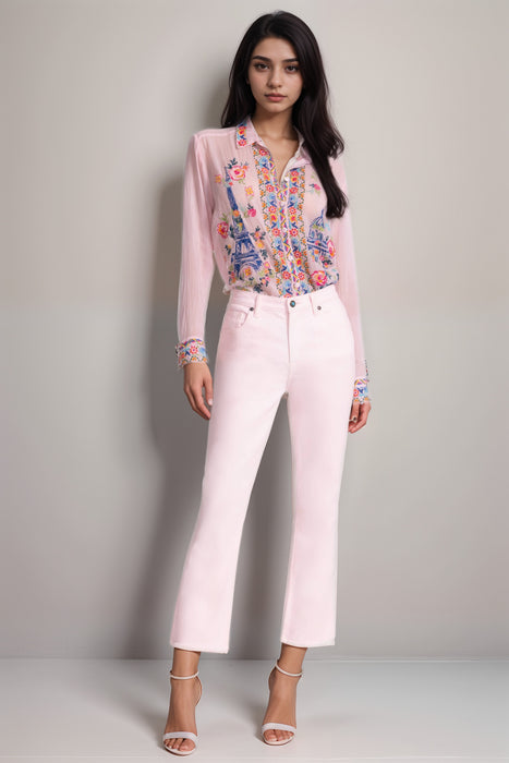 Woman wearing a washed pink denim with crop boot leg and distressed hem from Johnny Was