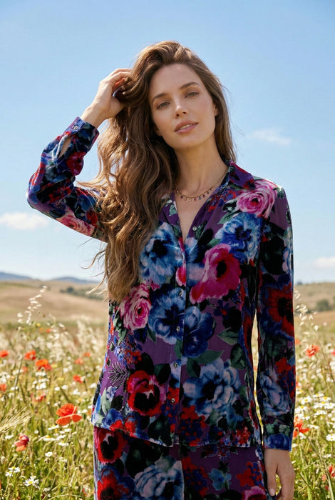 Woman wearing a long sleeve floral-patterned shirt with button down front form Johnny Was