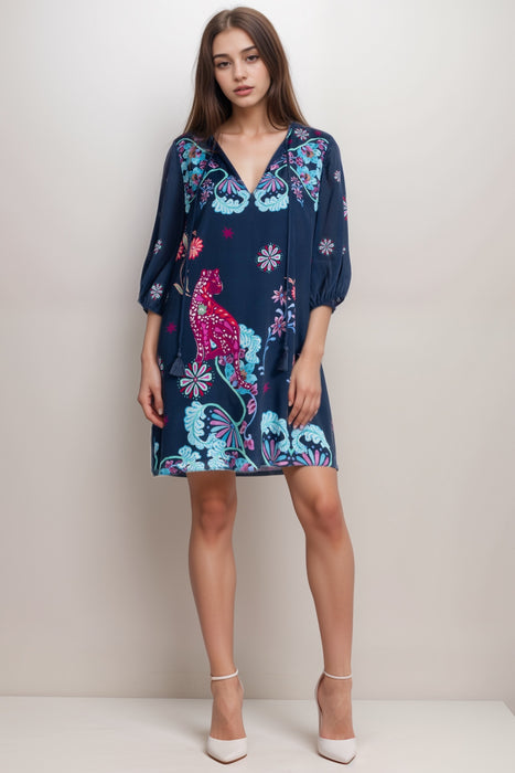 Woman wearing a blue mini dress with vibrant floral print