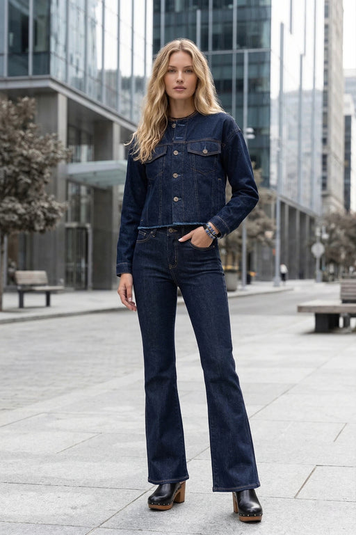 Woman wearing a dark blue button down denim jacket with raw neck and hem from Johnny Was