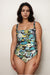 Woman wearing a floral one-piece swimsuit with square neck and ruching at the front from Johnny Was