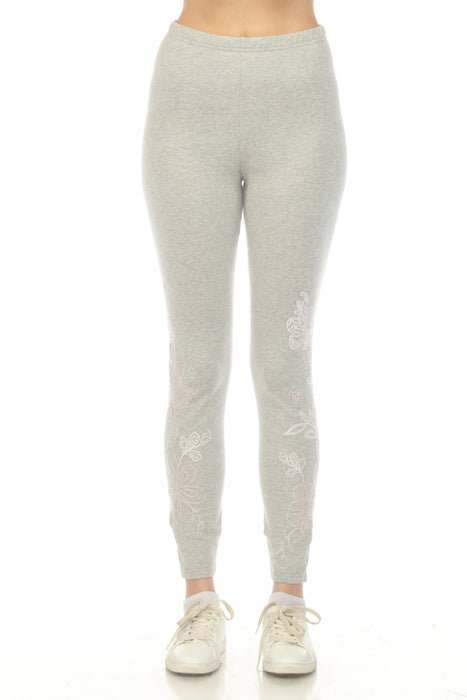 Woman wearing a grey legging with floral embroidery from Johnny Was