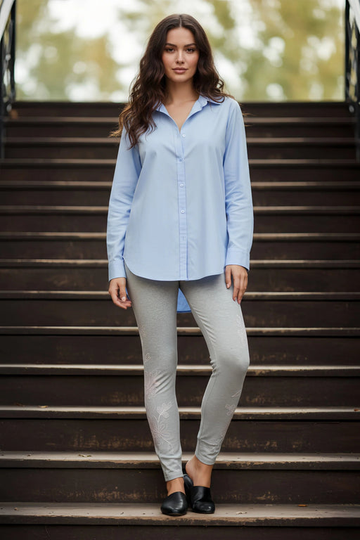 Woman wearing a grey legging with floral embroidery from Johnny Was