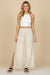 Woman wearing a white polka dots wide leg pants with high side slit from Johnny Was