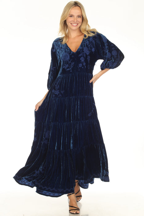 Woman wearing a navy blue velvet dress with floral embroidery and tiered skirt from Johnny Was