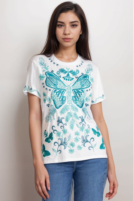 Woman wearing a white crew neck t-shirt with blue butterfly design embroidery