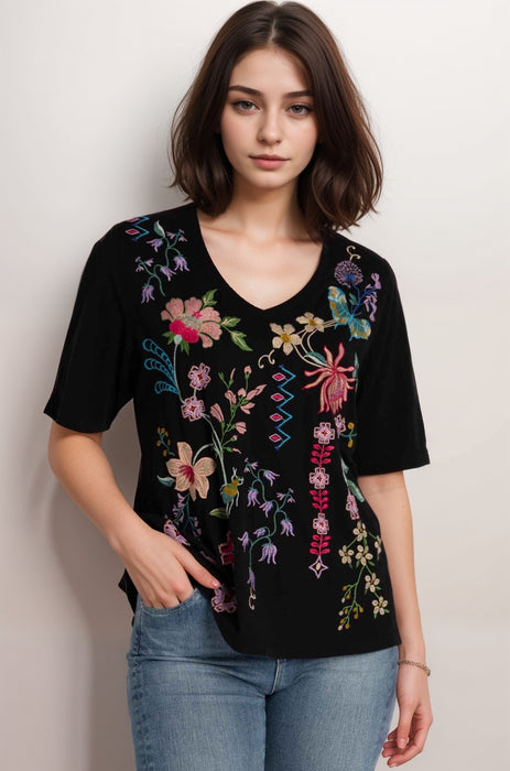 Woman wearing a black floral-embroidered t-shirt with v-neck from Johnny Was