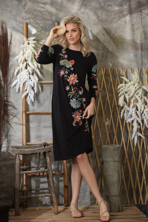 Woman in relaxed A-line cotton dress with embroidered details