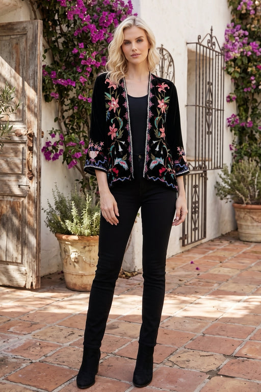 Woman wearing a black velvet kimono with colorful floral embroideries and 3/4 sleeves from Johnny Was