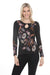 Woman wearing a black long sleeve top with floral embroidery and keyhole neckline from Johnny Was