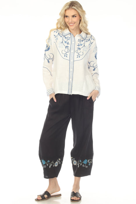 Woman wearing a black linen pant with cropped barrel leg and embroidered hem from Johnny Was
