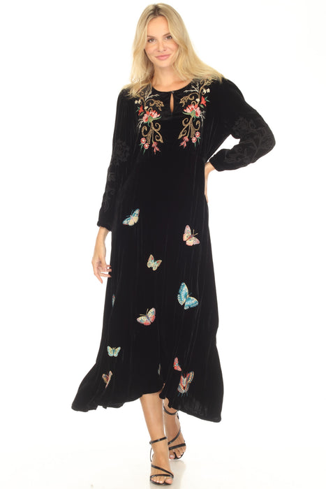 Woman wearing a black midi dress with floral and butterfly embroidery from Johnny Was