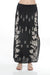 Woman wearing a black floral embroidered maxi skirt from Johnny Was