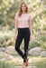 Woman wearing a black leggings with colorful floral embroidery along the sides from Johnny Was
